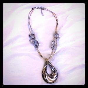 Glass necklace with silver and gold inside